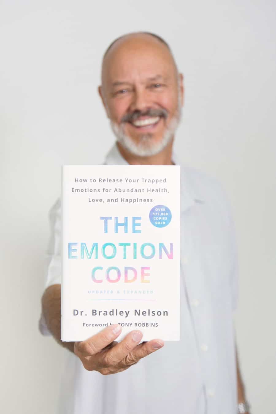 Dr. Bradley Nelson holding The Emotion Code